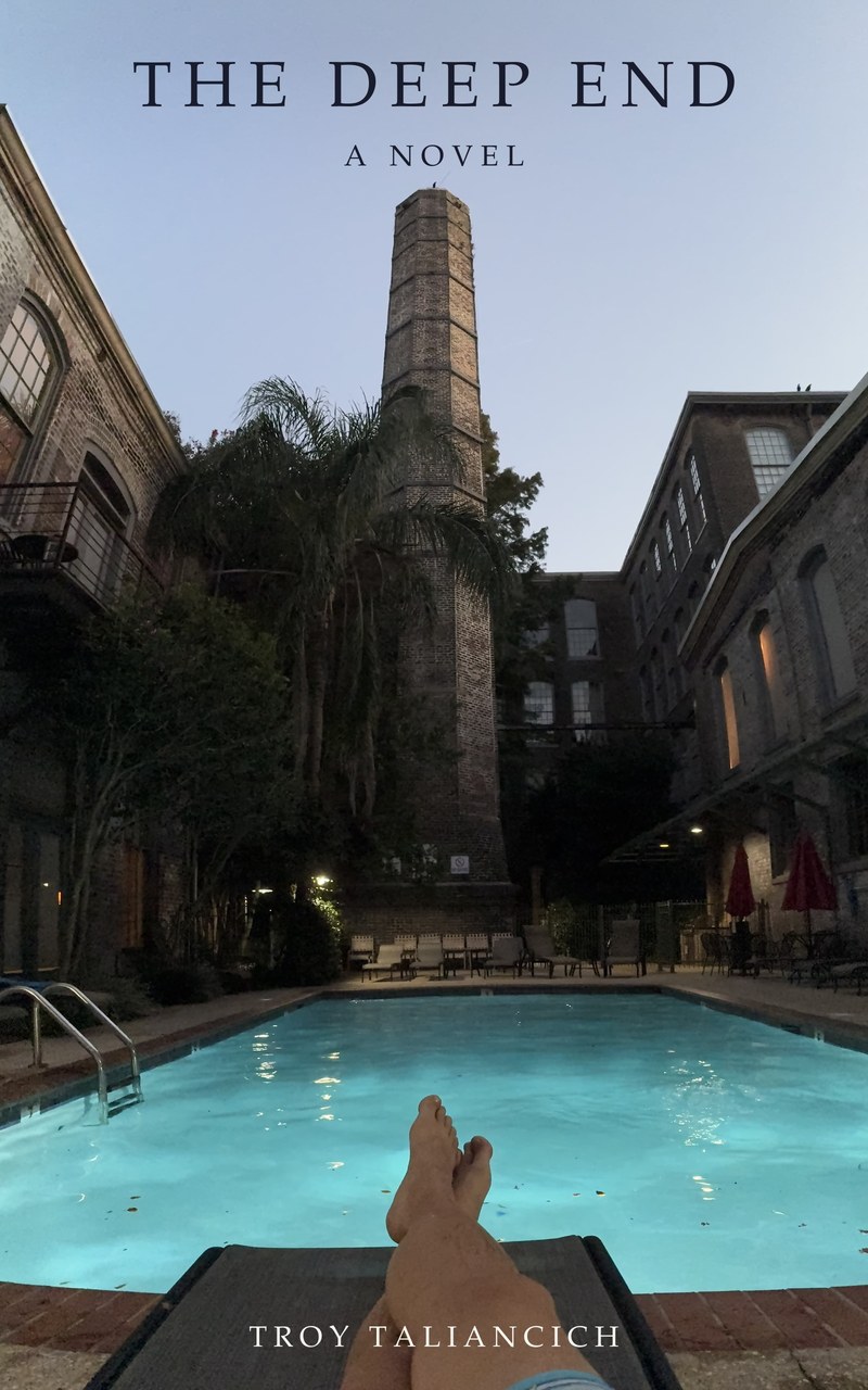 The Deep End — cover: the Cotton Mill pool at dusk, from a lounger, the brick smokestack against the sky